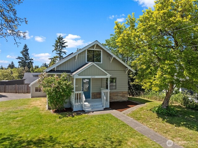 4822 S M St, Tacoma, WA 98408 - view of front of property with board and batten siding, a porch, and stone siding