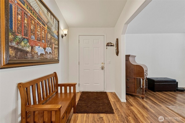 entryway with baseboards and wood finished floors