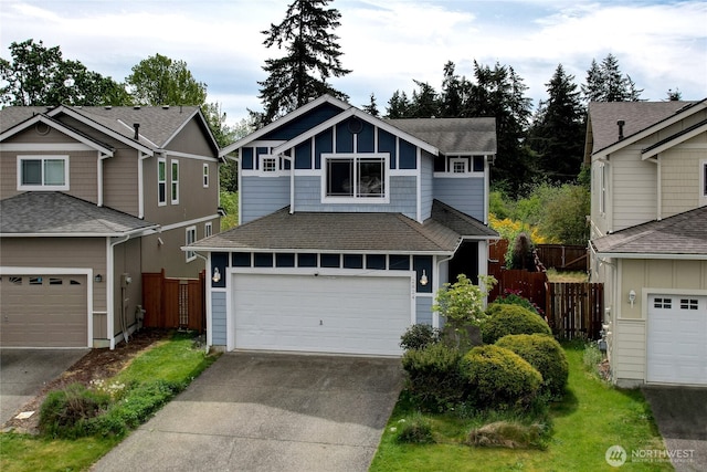 2824 187th St E, Tacoma, WA 98445 - view of front facade featuring fence, driveway, a shingled roof, and board and batten siding