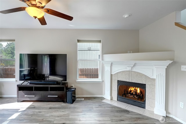 2824 187th St E, Tacoma, WA 98445 - living room featuring wood finished floors, a fireplace, baseboards, and a ceiling fan