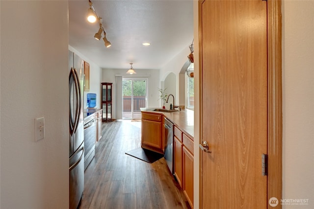 2824 187th St E, Tacoma, WA 98445 - kitchen with dishwasher, a sink, wood finished floors, arched walkways, and range