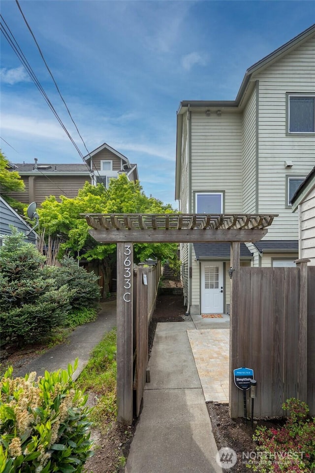 view of patio with a pergola and fence