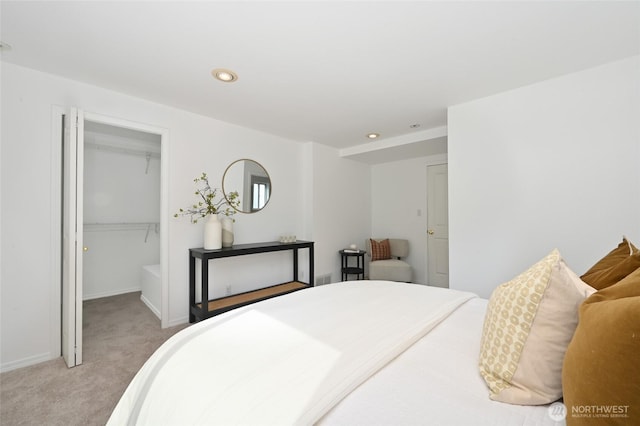 bedroom with carpet floors, a spacious closet, a closet, baseboards, and recessed lighting