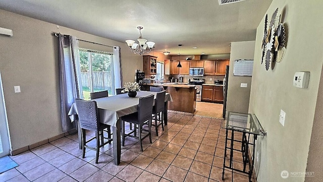 dining space featuring an inviting chandelier, light tile patterned flooring, and visible vents