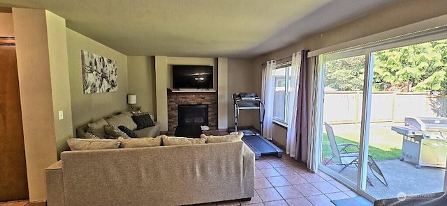 living area featuring light tile patterned floors and a fireplace with raised hearth