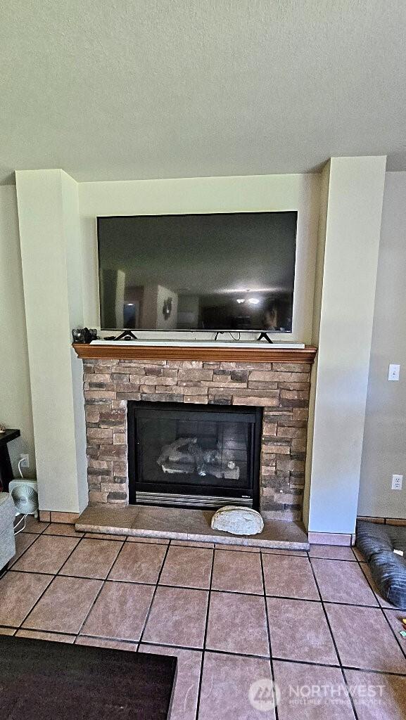 room details featuring a fireplace and a textured ceiling
