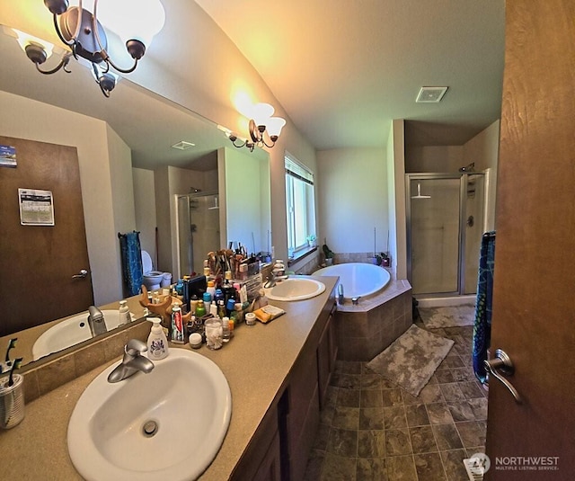 bathroom featuring a shower stall, a bath, visible vents, and a sink
