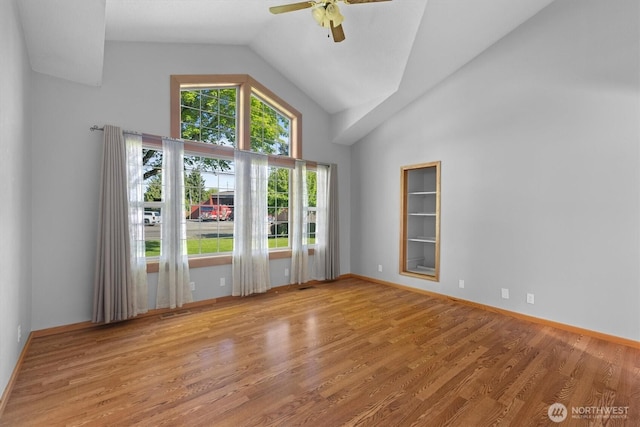 2350 38th Ave, Longview, WA 98632 - spare room featuring high vaulted ceiling, ceiling fan, wood finished floors, and baseboards