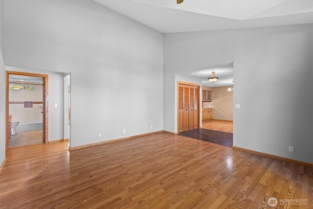 2350 38th Ave, Longview, WA 98632 - unfurnished room with wood finished floors, baseboards, and a towering ceiling