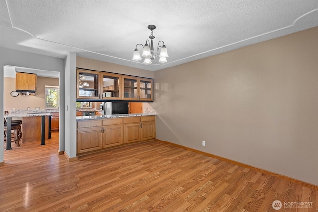 2350 38th Ave, Longview, WA 98632 - unfurnished dining area with light wood finished floors, a chandelier, baseboards, and a textured ceiling