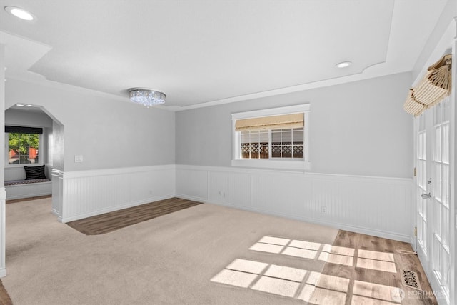 2350 38th Ave, Longview, WA 98632 - empty room with a wainscoted wall, arched walkways, crown molding, carpet floors, and a chandelier