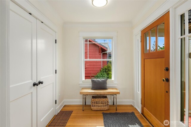 entryway featuring light wood-style floors and baseboards