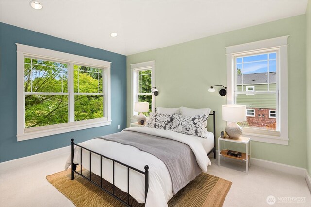 carpeted bedroom with multiple windows, baseboards, and recessed lighting