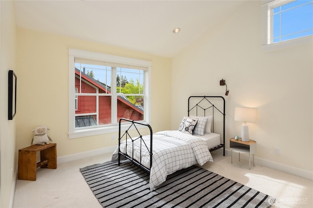 bedroom with carpet flooring, baseboards, and lofted ceiling