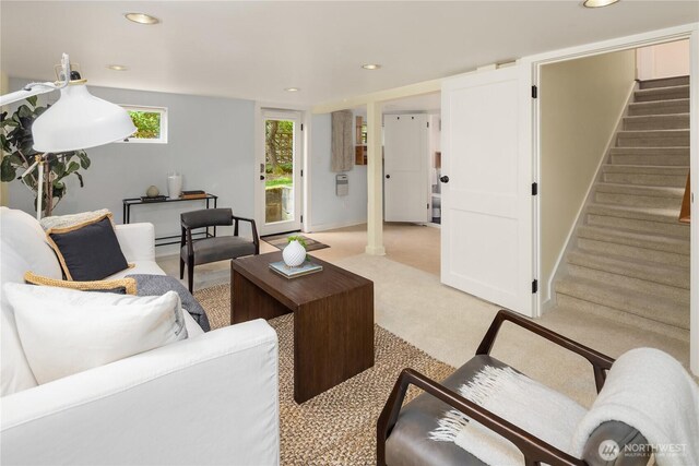living area featuring stairs, light carpet, and recessed lighting