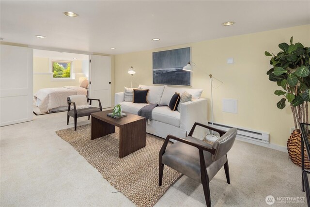 carpeted living area with baseboard heating and recessed lighting