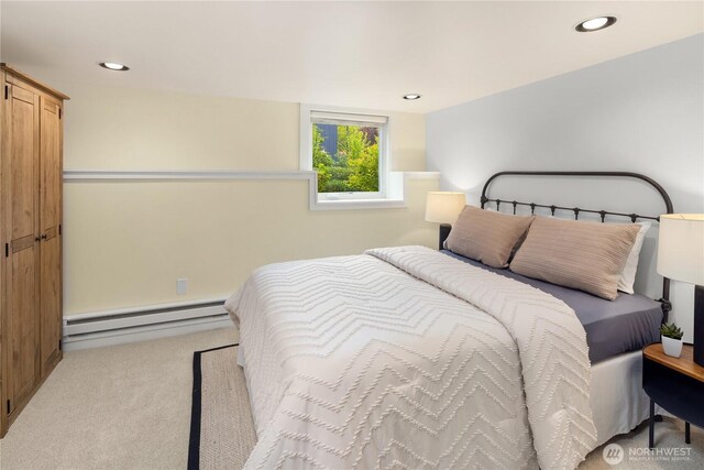 bedroom with baseboard heating, carpet flooring, and recessed lighting