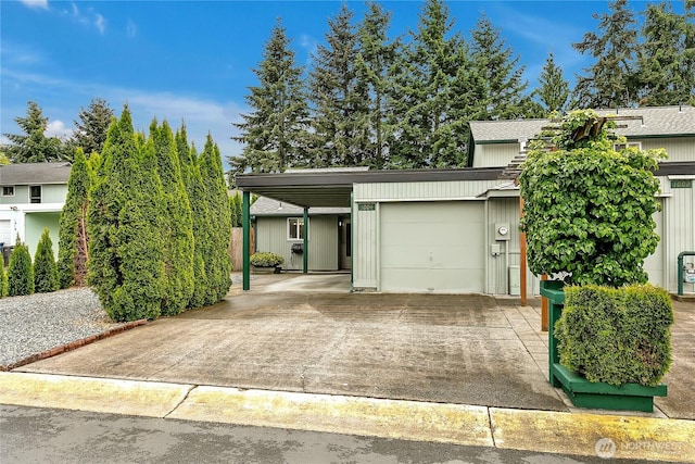 1004 30th St NE, Auburn, WA 98002 - view of front of house with a carport, concrete driveway, an attached garage, and roof with shingles