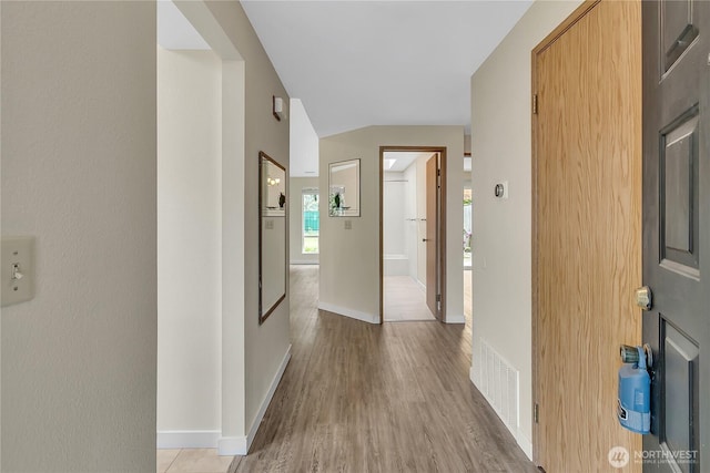 1004 30th St NE, Auburn, WA 98002 - corridor featuring light wood-type flooring, baseboards, and vaulted ceiling