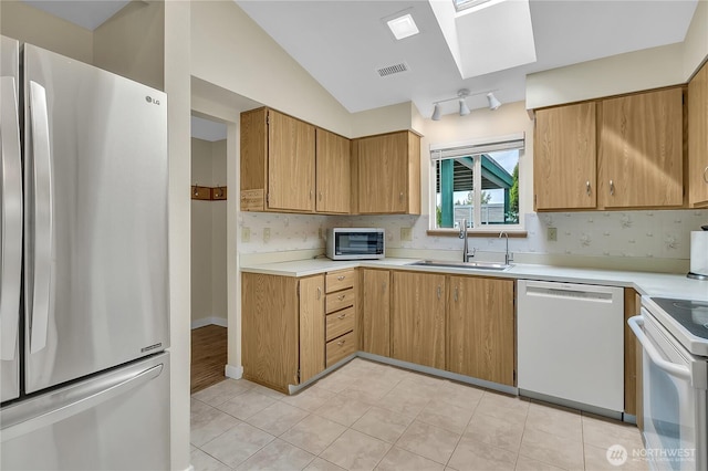 1004 30th St NE, Auburn, WA 98002 - kitchen with white appliances, a sink, light countertops, backsplash, and lofted ceiling