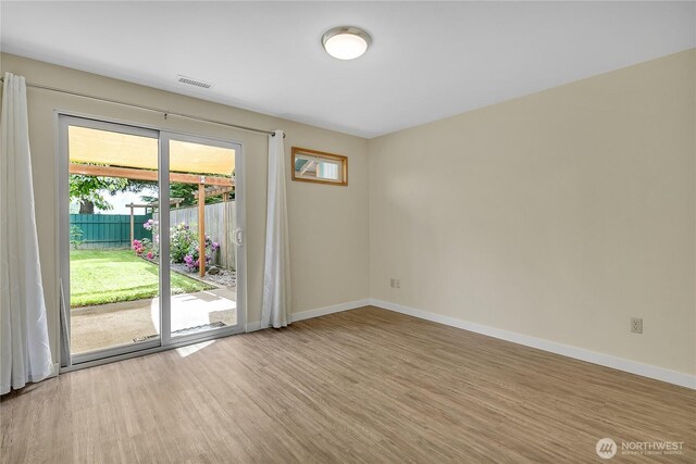 1004 30th St NE, Auburn, WA 98002 - unfurnished room with wood finished floors and baseboards