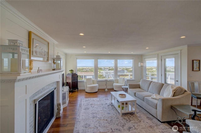1005 346th Pl, Ocean Park, WA 98640 - living room featuring a premium fireplace, healthy amount of natural light, ornamental molding, wood finished floors, and recessed lighting