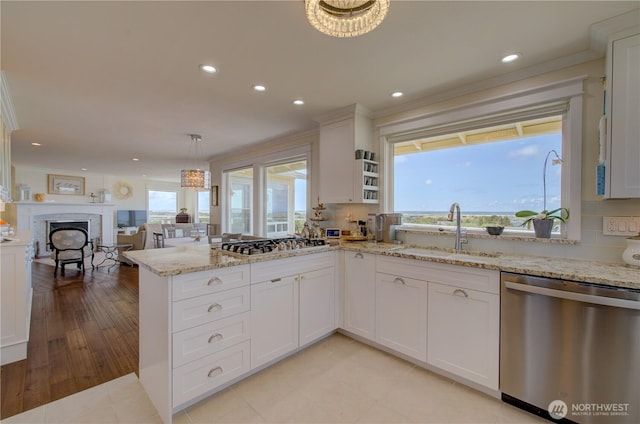 1005 346th Pl, Ocean Park, WA 98640 - kitchen with stainless steel appliances, a sink, a peninsula, recessed lighting, and white cabinets