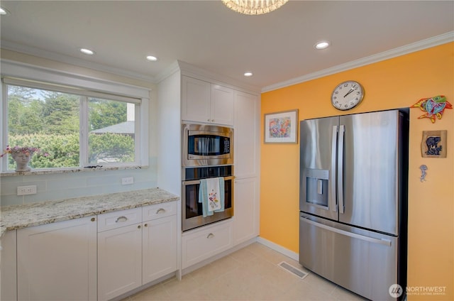 1005 346th Pl, Ocean Park, WA 98640 - kitchen featuring stainless steel appliances, crown molding, white cabinets, baseboards, and light stone counters