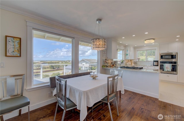 1005 346th Pl, Ocean Park, WA 98640 - dining space featuring ornamental molding, wood finished floors, recessed lighting, and baseboards