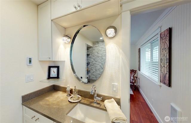 1005 346th Pl, Ocean Park, WA 98640 - bathroom featuring wood finished floors, ornamental molding, vanity, and baseboards