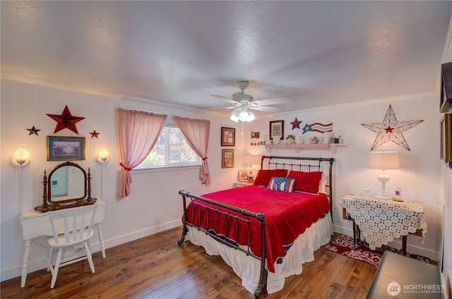 1005 346th Pl, Ocean Park, WA 98640 - bedroom featuring wood-type flooring, baseboards, crown molding, and a ceiling fan