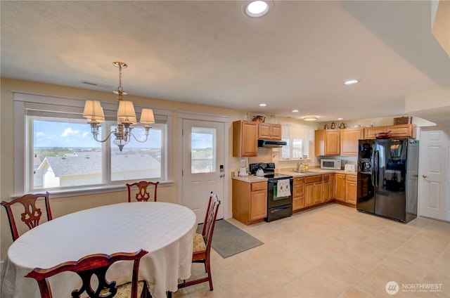 1005 346th Pl, Ocean Park, WA 98640 - kitchen featuring black appliances, a sink, light countertops, a chandelier, and under cabinet range hood