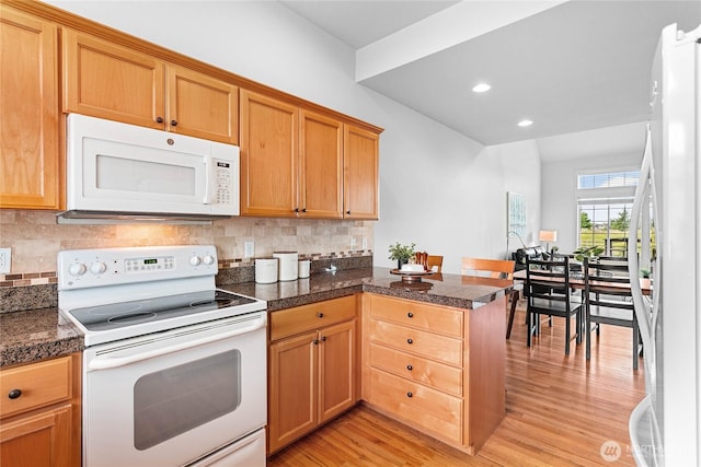 1725 Harrison Pl Unit 103, Lynden, WA 98264 - kitchen featuring white appliances, tile countertops, a peninsula, light wood finished floors, and backsplash
