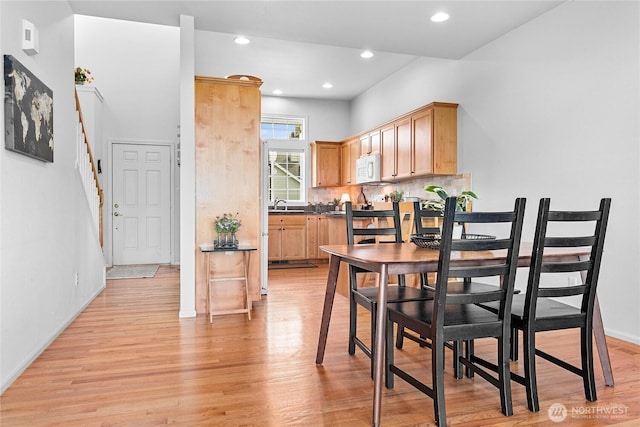 1725 Harrison Pl Unit 103, Lynden, WA 98264 - dining area with light wood-type flooring, recessed lighting, baseboards, and stairway