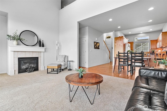 1725 Harrison Pl Unit 103, Lynden, WA 98264 - living room featuring carpet flooring, stairway, a tile fireplace, recessed lighting, and baseboards