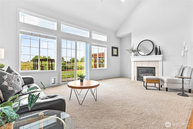 1725 Harrison Pl Unit 103, Lynden, WA 98264 - carpeted living area featuring high vaulted ceiling, a tile fireplace, and baseboards