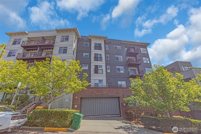 3333 Wallingford Ave N Unit 408, Seattle, WA 98103 - view of building exterior featuring concrete driveway and an attached garage