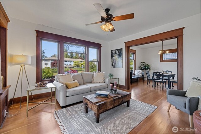 3301 Mckinley Ave, Tacoma, WA 98404 - living room featuring ceiling fan, light wood-style flooring, and baseboards