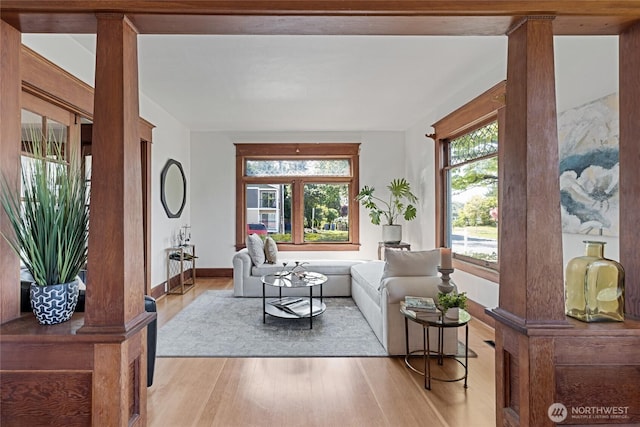 3301 Mckinley Ave, Tacoma, WA 98404 - living area featuring decorative columns, wood finished floors, and baseboards