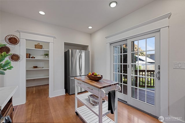 3301 Mckinley Ave, Tacoma, WA 98404 - doorway to outside with baseboards, light wood finished floors, recessed lighting, and built in shelves