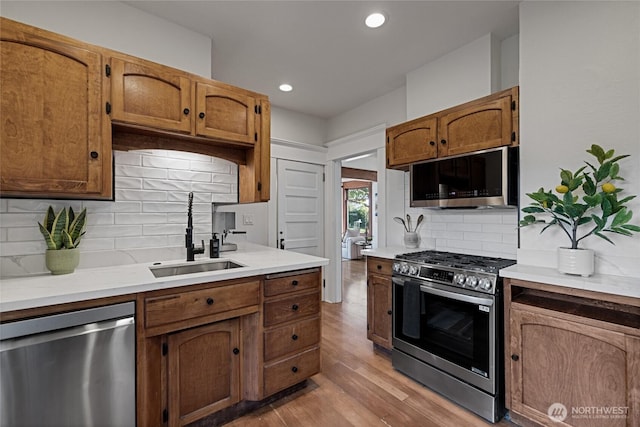 3301 Mckinley Ave, Tacoma, WA 98404 - kitchen featuring backsplash, light countertops, appliances with stainless steel finishes, and a sink