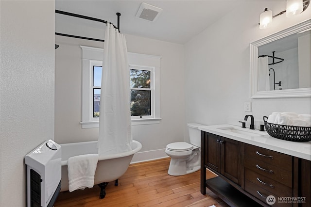 3301 Mckinley Ave, Tacoma, WA 98404 - full bath featuring toilet, hardwood / wood-style floors, vanity, visible vents, and a freestanding tub