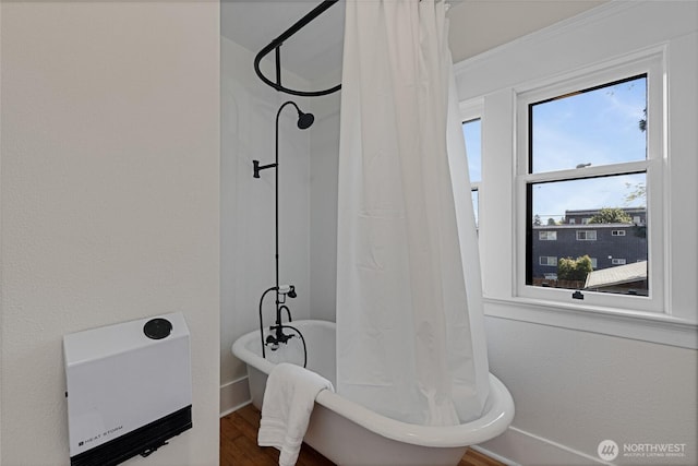 3301 Mckinley Ave, Tacoma, WA 98404 - bathroom with heating unit, a freestanding bath, a shower with shower curtain, and wood finished floors