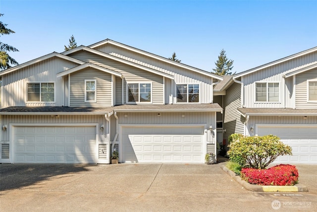 multi unit property with a garage and driveway