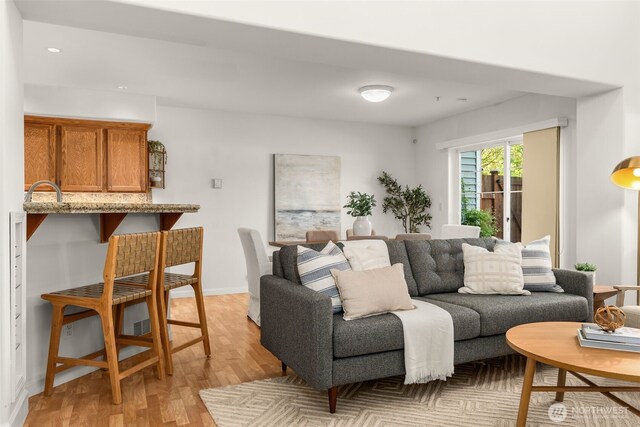 living area with light wood-style flooring and recessed lighting