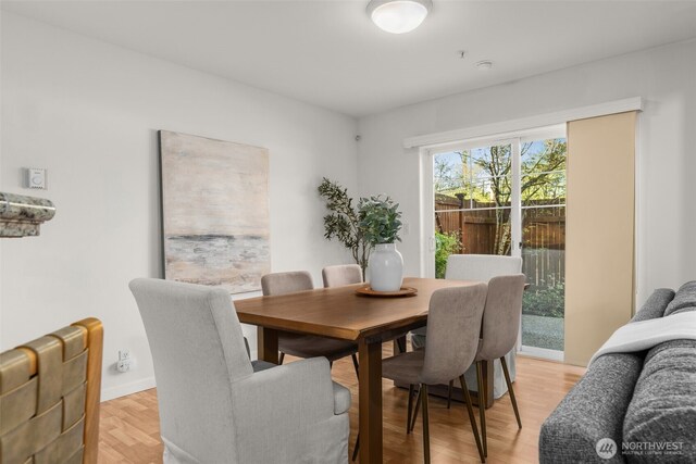 dining space featuring light wood-style flooring