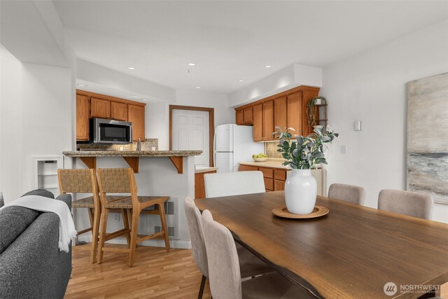 dining room featuring light wood-style floors and recessed lighting