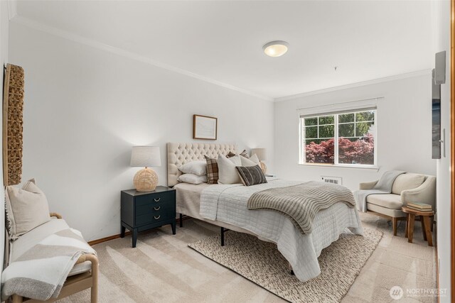 bedroom with ornamental molding and baseboards