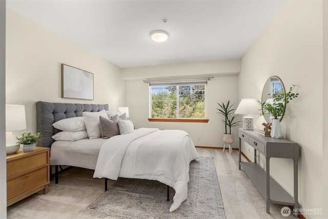 bedroom featuring light colored carpet