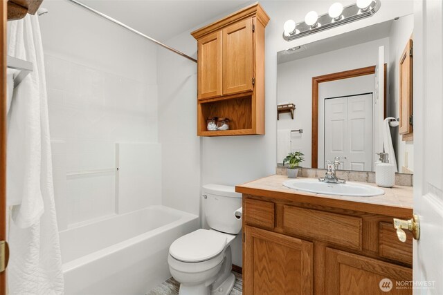 full bathroom featuring toilet, vanity, and shower / bath combination with curtain